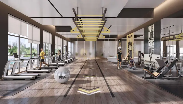 Clubhouse gymnasium with treadmills facing full-height glazing at Dosti Greenscapes