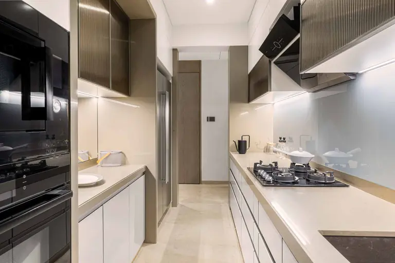 Kitchen in the show flat at Dosti Greenscapes, with marble-supported platform and stainless steel sink