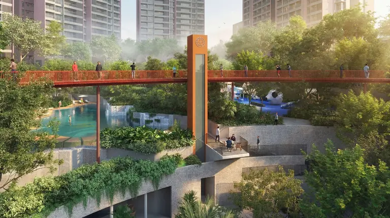 The podium connectivity bridge and clock tower crossing the landscaped grove at Yashada EVO, Punawale