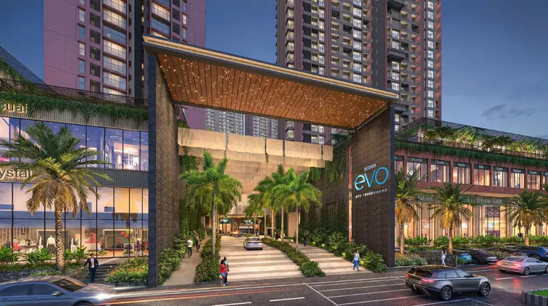 The arrival gateway at Yashada EVO, Punawale, with palms and the high street on either side and the towers behind