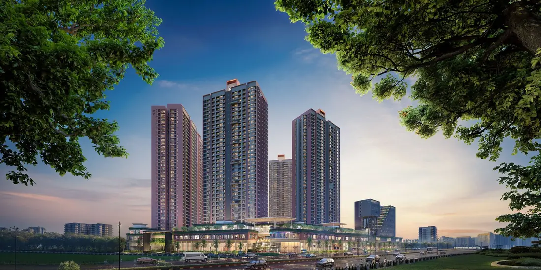 Yashada EVO, Punawale, Pune — the residential towers rising behind the highway high street at dusk